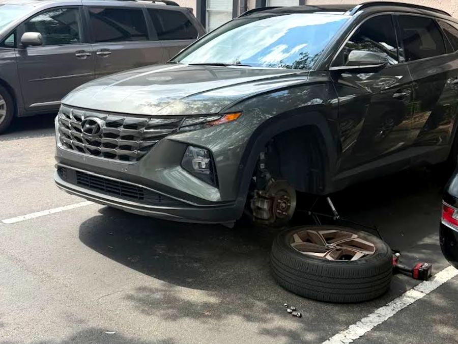 Brake rotor and caliper exposed during a mobile brake repair