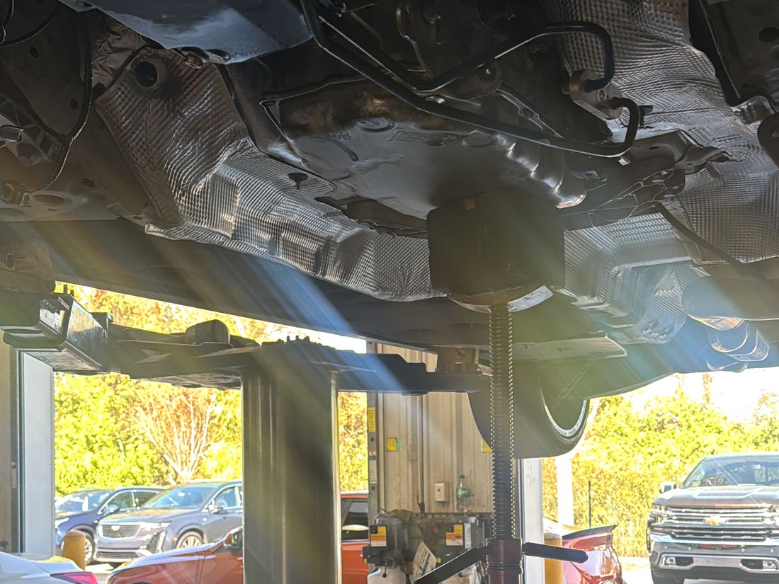 Vehicle raised on a two-post lift in the shop